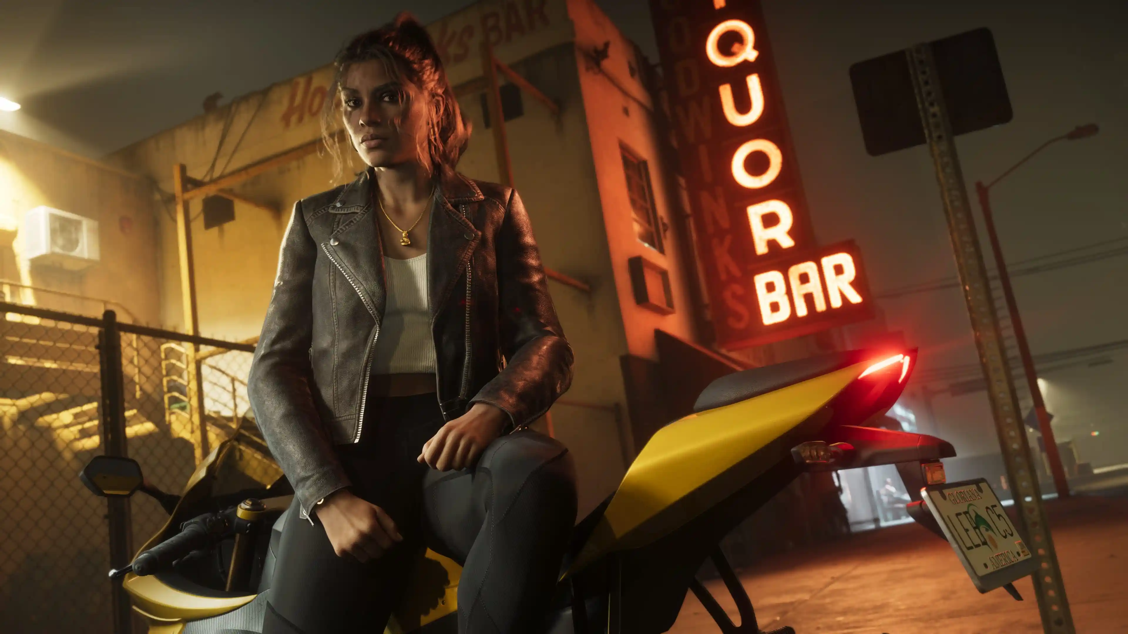 Lucia leaning on a motorcycle at night