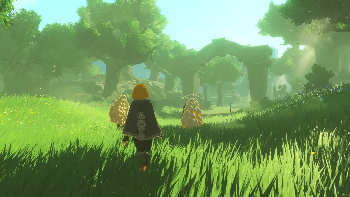 Zelda from behind crossing a sunny meadow toward a stone arch, with two fluffy figures beside her