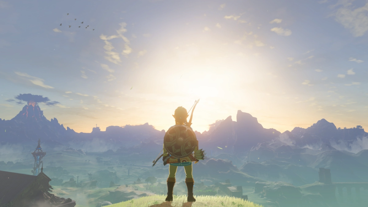 Link de espaldas ante un valle de Hyrule al amanecer, con Death Mountain a lo lejos