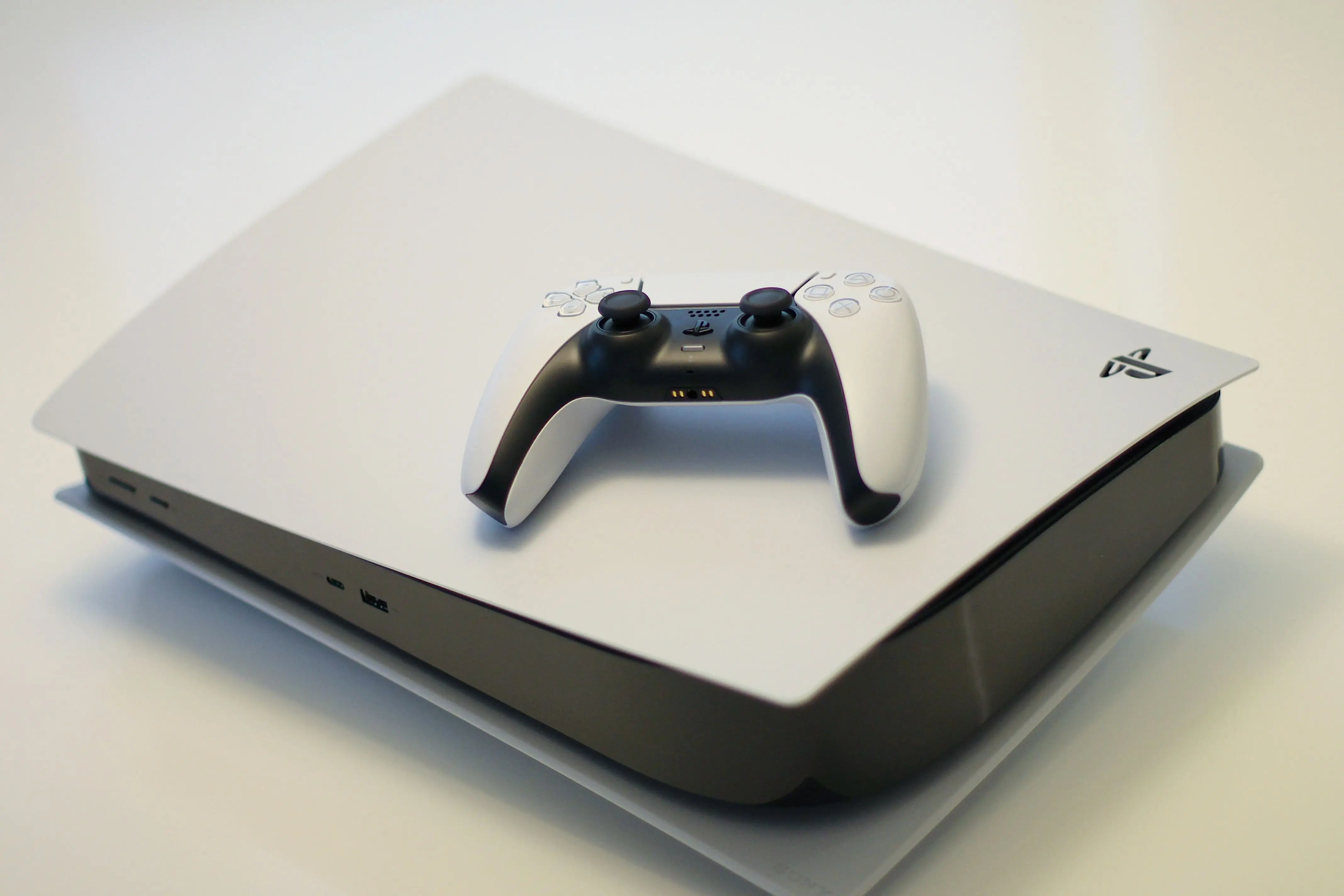 PlayStation 5 with two controllers resting on top