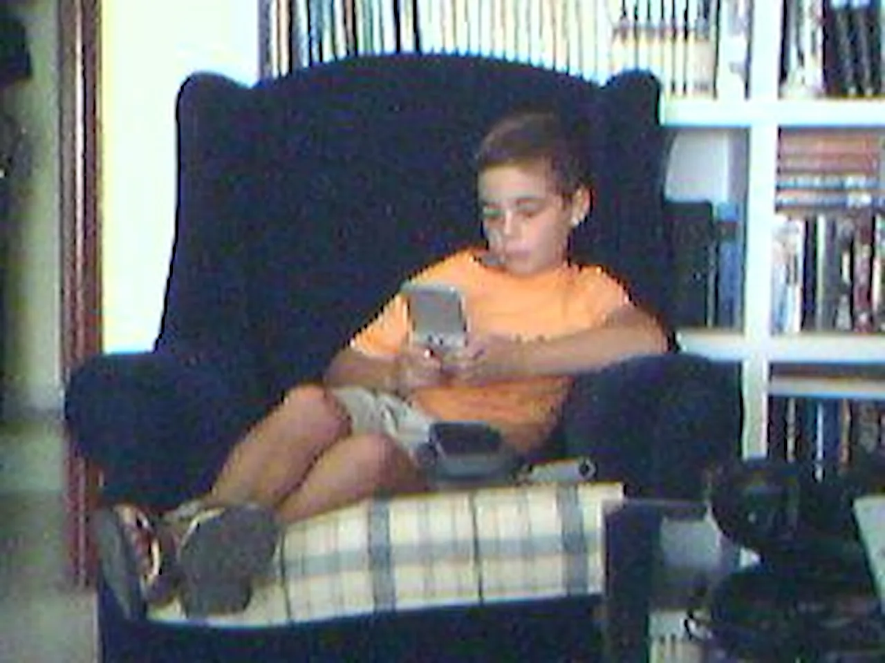 A cool kid playing on his Game Boy